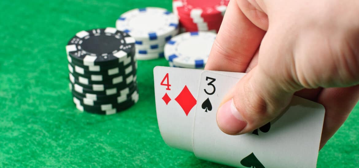 poker,chips,and,a,hand,flip,the,cards,isolated,against